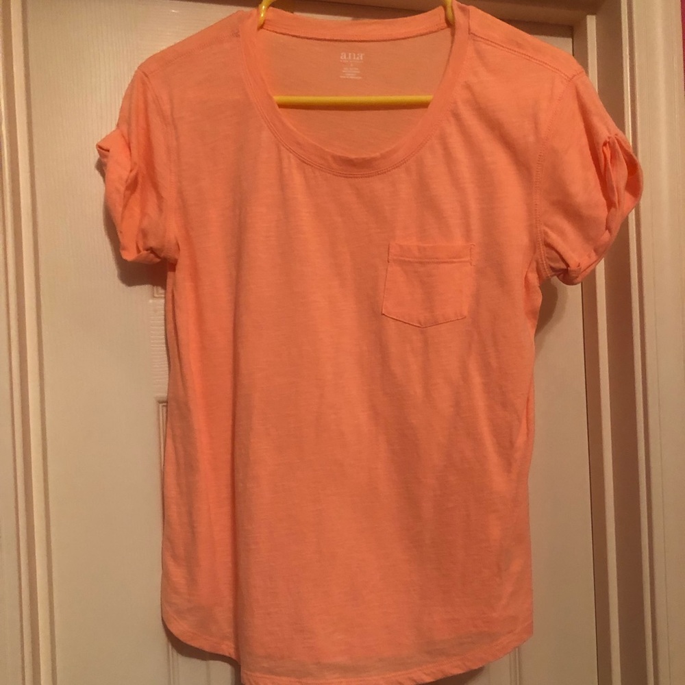 An orange crew neck shirt.